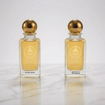 Two perfume bottles with gold caps on a reflective surface.